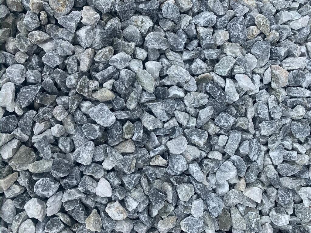 Close-up photo of blue metal gravel, illustrating its texture and usage in landscaping and construction.