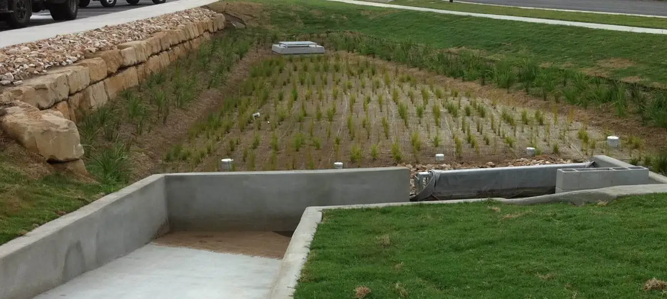 Photo of a drainage system integrated with landscaping, illustrating water management and outdoor design.