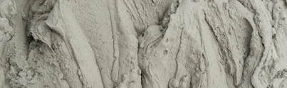 Close-up photo of mixed cement, showing texture and consistency for construction or masonry work.