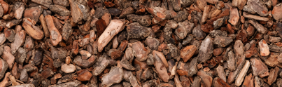 Close-up of pine bark mulch, showing natural texture and color variations.